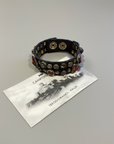 Bracelet. Leather+ stud+ red triangular rhinestones. Color: Grey. X2867 C0501.