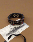Bracelet. Leather+ stud+ red triangular rhinestones. Color: Grey. X2867 C0501.